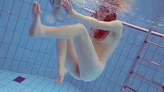Solo model with the red hair decides to get naked under the water