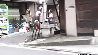 Japanese babe Street Sharking in front of a vending machine.