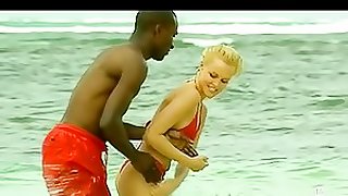 Interracial Couple Having Fun Outdoors On The Beach