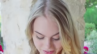 A blonde that has nice tits is alone outdoors, and she is nude