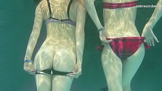 Nice ass lesbain in bikini swimming with her babe in pool