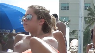 Topless beach girl with massive tits