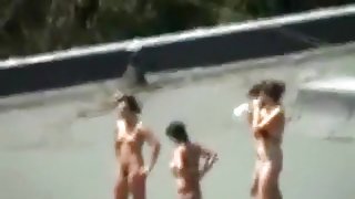 Voyeur tapes 4 girls tanning with their boobs naked on a roof with his cellphone