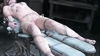 Blonde ponytailed doll gagged and bound punished with hot wax