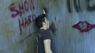 Handsome gay giving massive dick blowjob through gloryhole