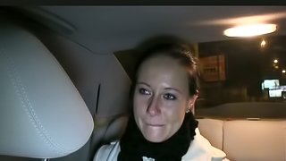 A brunette girl gets fucked fucked in a missionary pose in a car